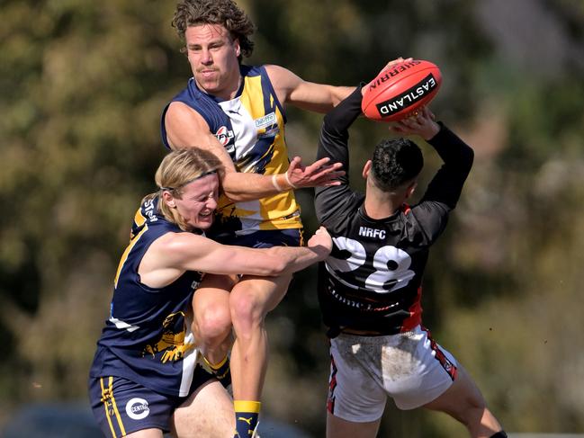 EFNL: Beaconsfield pair Benjamin Schultze and Joshua Mounter tangle with North Ringwood’s Robin Nahas. Picture: Andy Brownbill