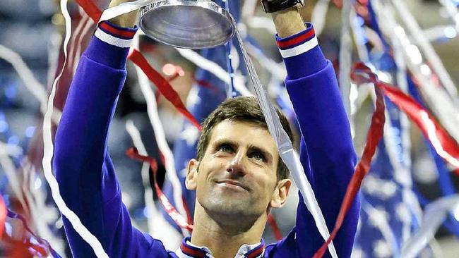 NEW YORK STATE OF MIND: Novak Djokovic holds up the championship trophy after defeating Roger Federer in the US Open final. Picture: Julio Cortezaap