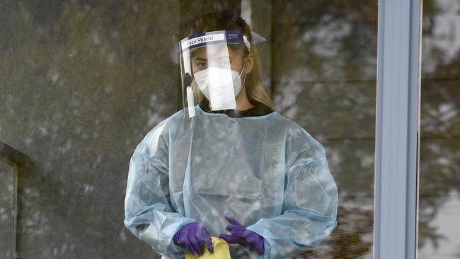 A worker wearing full PPE cleans surfaces at Arcare Maidstone Aged Care in Melbourne's west after the facility went into lockdown. Picture: NCA NewsWire / Andrew Henshaw