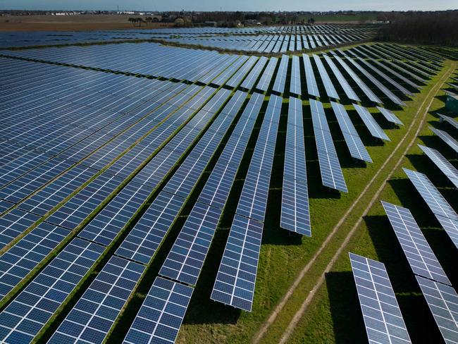 An aerial view shows the photovoltaic (PV) solar panels making up Manston Solar Farm, in south-east England on March 18, 2024. (Photo by Daniel LEAL / AFP)