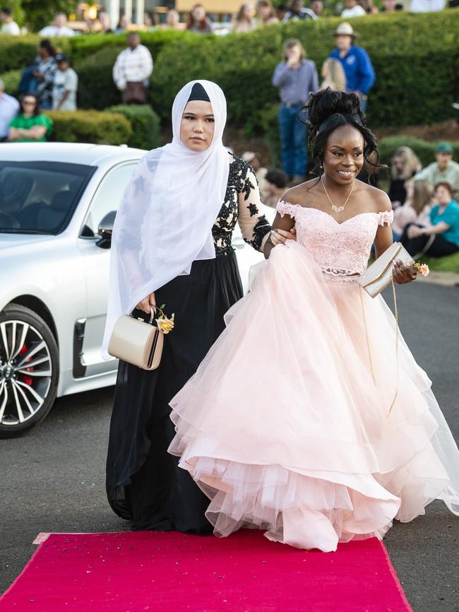 Sakina Damarda (left) and Neema Mwamba Wilongella arrive at Harristown State High School formal at Highfields Cultural Centre, Friday, November 18, 2022. Picture: Kevin Farmer