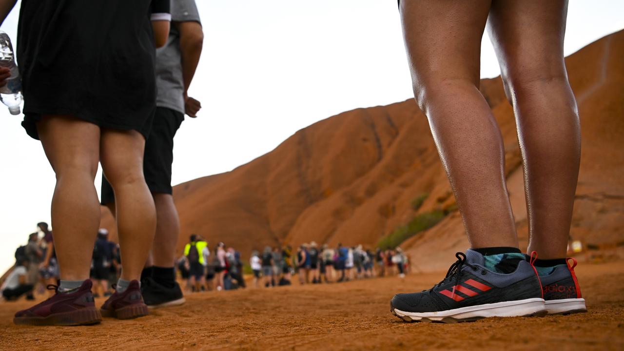 Tourists are seen lining up to climb Uluru, also known as Ayers Rock at Uluru-Kata Tjuta National Park in the Northern Territory. Picture: AAP/Lukas Coch