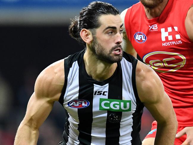 Brodie Grundy of the Magpies (left) is crowded by Jarrod Witts of the Suns during the Round 15 AFL match between the Gold Coast Suns and the Collingwood Magpies at Metricon Stadium at Carrara on the Gold Coast, Saturday, June 30, 2018. (AAP Image/Dan Peled) NO ARCHIVING, EDITORIAL USE ONLY