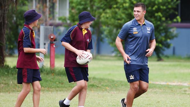 North Queensland Cowboys players Scott Drinkwater and Corey Jensen have visited St Augustine's College to work with Grade 8 physical education students. St Augustine's students Harry Riordan and Dane Salernon pass to Scott Drinkwater. PICTURE: BRENDAN RADKE