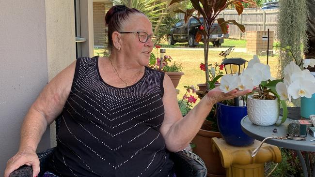 Glenella mum Robyn 'Robbi' Mapley tenderly cradles an orchid he gifted her about 12 months ago before she went into hospital.