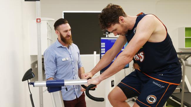 CQUniversity Exercise and Sports Science Lecturer Dr. Joshua Guy runs Cairns Taipans co captain Alex Loughton through a static bicycle that is linked to precision instruments and computer analysis software. PICTURE: BRENDAN RADKE