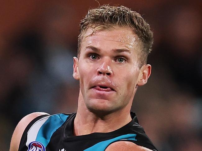 ADELAIDE, AUSTRALIA - APRIL 13: Dan Houston of the Power kicks the ball during the 2024 AFL Round 05 match between the Port Adelaide Power and the Fremantle Dockers at Adelaide Oval on April 13, 2024 in Adelaide, Australia. (Photo by James Elsby/AFL Photos via Getty Images)