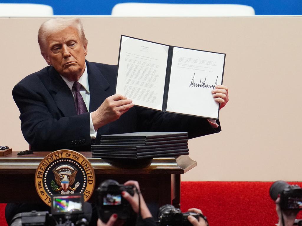 US President Donald Trump holds up an executive order after signing it. Picture: Getty Images via AFP