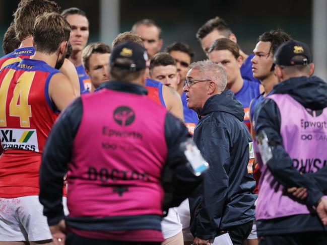 Lions head coach Chris Fagan speaks to players at three quarter time during the round 6 AFL match between the Geelong Cats and the Brisbane Lions at Sydney Cricket Ground. Picture: MATT KING/AFL PHOTOS/VIA GETTY IMAGES