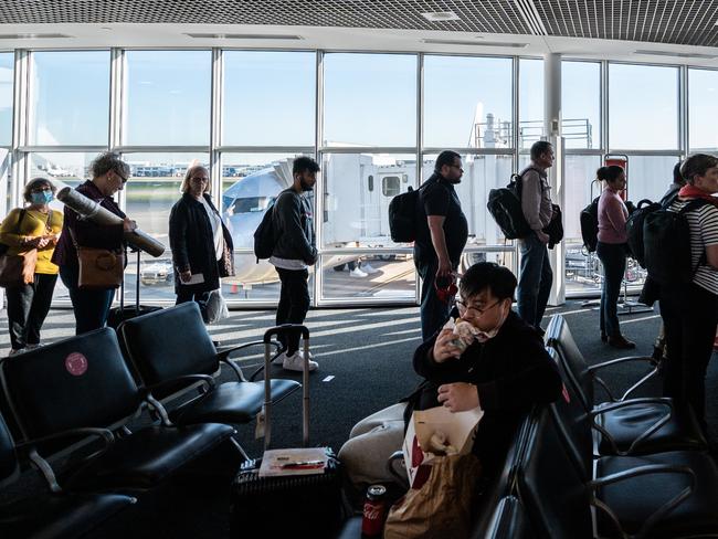 Passengers waiting to board a flight at Sydney Airport. Picture: AAP.