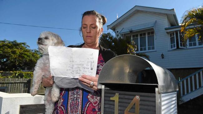 POISONED PET: Tracey Spoor and her surviving dog Yoppy with the letter she received threatening her dog and children. Picture: Cody Fox