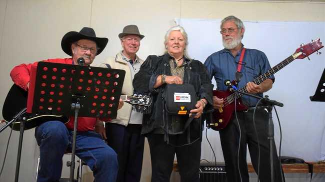 CLASSIC COUNTRY: Rob McCalister and Henry Wilson with Cammie and Charlie Bastow with the new defibrillator machine. Picture: Kate McCormack