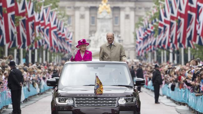 Queen Elizabeth II and Prince Philip drive down The Mall during celebrations for the Queen's 90th birthday in 2016. Picture: Getty Images.