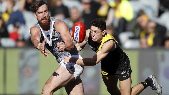 Charlie Dixon of the Power is tackled by Jason Castagna of the Tigers.