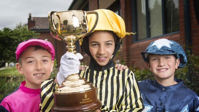 Holy Name Primary School Reservoir students Mitchell, Terence and Luke with the Melbourne Cup. Picture: Eugene Hyland