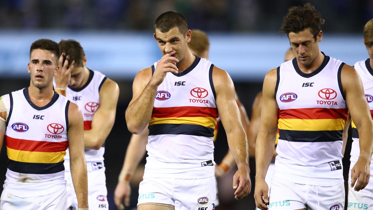 Taylor Walker of the Crows and his teammates leave the field after losingto the Kangaroos. Picture: Scott Barbour/Getty Images