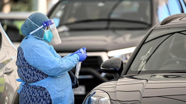 A health worker registers a resident at a Covid-19 coronavirus drive through testing site on Bondi Beach in Sydney on June 17, 2021. (Photo by Saeed KHAN / AFP)