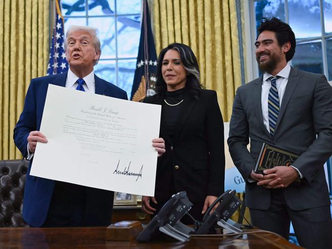 Donald Trump, Tulsi Gabbard and her husband Abraham Williams. Ms Gabbard oversees US intelligence services and was seen as another controversial pick by Mr Trump. Picture: AFP