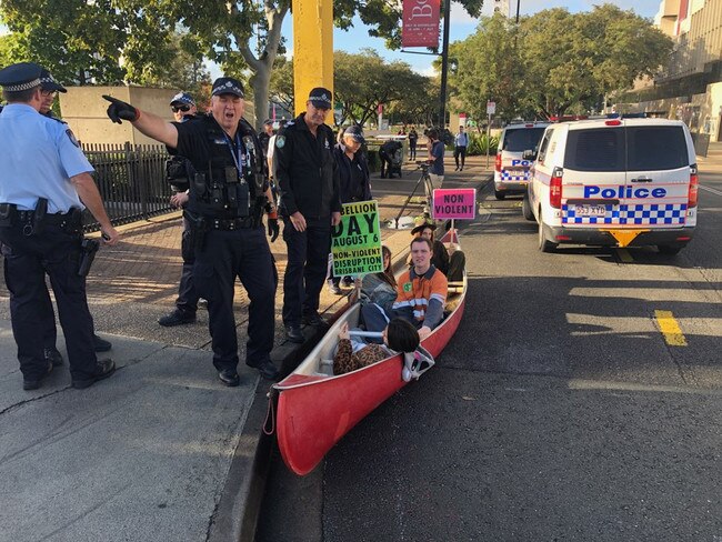 Four activists have locked themselves onto the canoe using metal pipes, meaning they will be unable to be removed without being cut out. Picture: Andrea Macleod