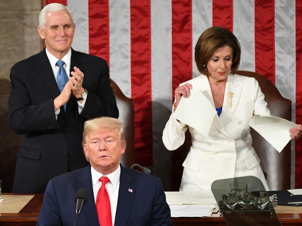 Mike Pence claps as Speaker of the US House Nancy Pelosi appears to rip a copy of Donald Trump’s speech after he delivers the State of the Union address. Picture: AFP