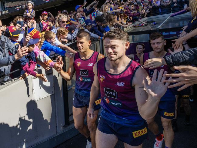 Brandon Starcevich and Lachie Neale lead the Lions out at an open training session. Picture Lachie Millard