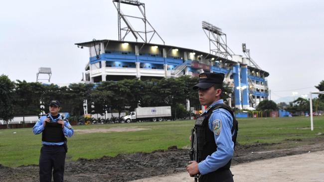 Police officers stand guard outside the Olimpico Metropolitano.