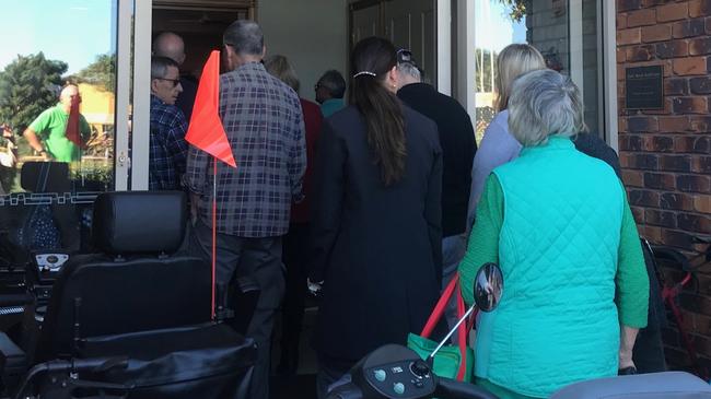 Residents and family from Earle Haven retirement village pack into the auditorium for a meeting about abrupt closure of the nursing home.