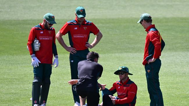 Mac Wright is treated for an injury during the Marsh One Day Cup match between Tasmania and Western Australia at Blundstone Arena. (Photo by Steve Bell/Getty Images)