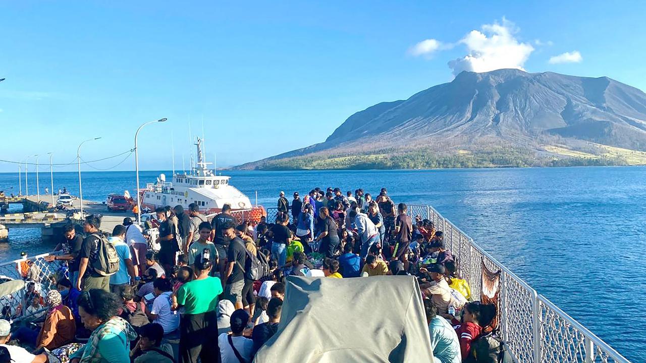Residents of Tagulandang Island being evacuated by a navy ship more than a week ago after Mount Ruang volcano erupted. Picture: Indonesia's National Disaster Management Agency (BNPB) / AFP