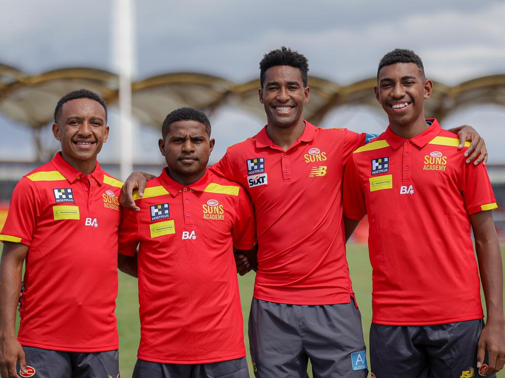 Hewago Oea of the Gold Coast SUNS with upcoming PNG athletes from the SUNS Academy