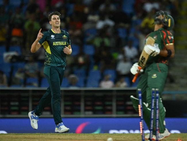 Australia's Pat Cummins (L) celebrates bowling out Bangladesh's Mahmudullah (R). Picture: Andrew Caballero-Reynolds / AFP