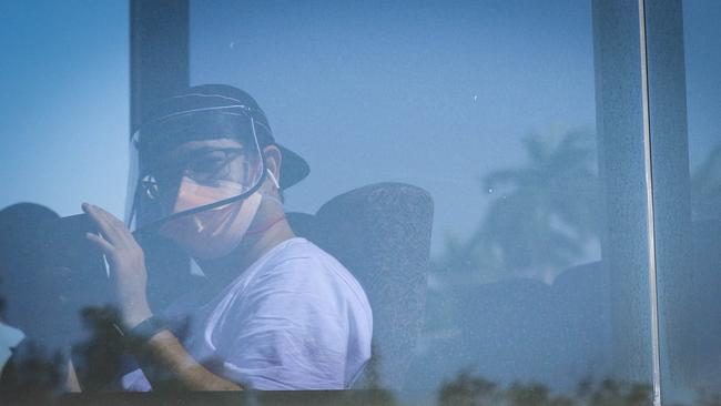 Passengers from the flight are transported from RAAF BASE Darwin to the Howard Springs quarantine facility on-board buses. Picture: Glenn Campbell