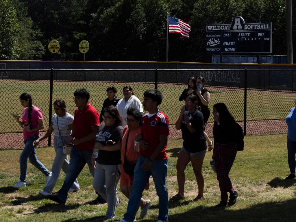 Students leave the scene of another school shooting. Picture: AFP