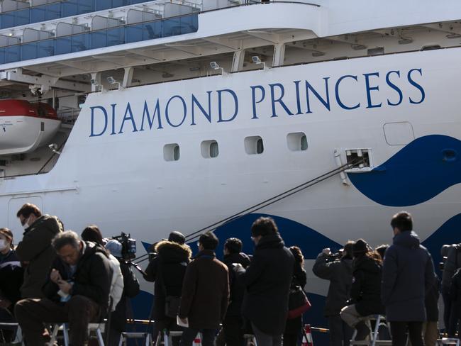 Media gather outside the quarantined Diamond Princess cruise ship in Yokohama, near Tokyo, Tuesday, Feb. 11, 2020. Japan's Health Minister Katsunobu Kato said the government was considering testing everyone remaining on board and crew on the Diamond Princess, which would require them to remain aboard until results were available. (AP Photo/Jae C. Hong)