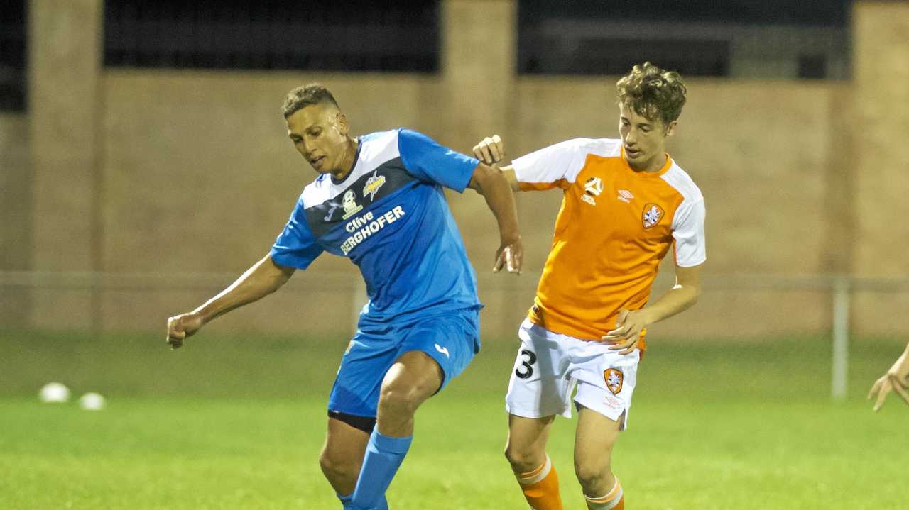 IN CONTROL: Thunder striker Travis Cooper (left) holds off Brisbane Roar player Kai Trewin during their match last week. Picture: Nev Madsen