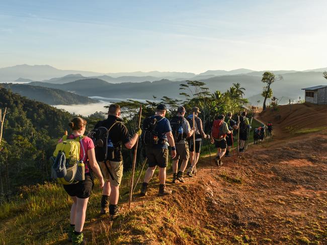 10 South Australians and their porters from Buna pass the village of Nauro on the Kokoda Trek August 2018. Picture: Brad Fleet