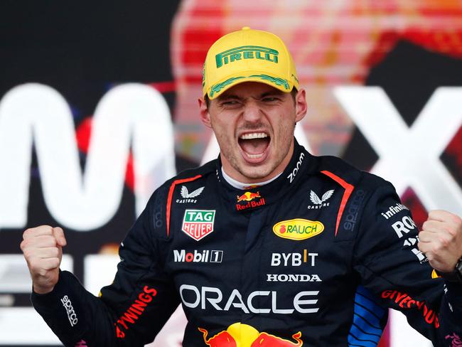 TOPSHOT - Red Bull Racing's Dutch driver Max Verstappen celebrates at the podium of the Formula One Sao Paulo Grand Prix, at the Jose Carlos Pace racetrack, aka Interlagos, in Sao Paulo, Brazil, on November 3, 2024. (Photo by Miguel Schincariol / AFP)