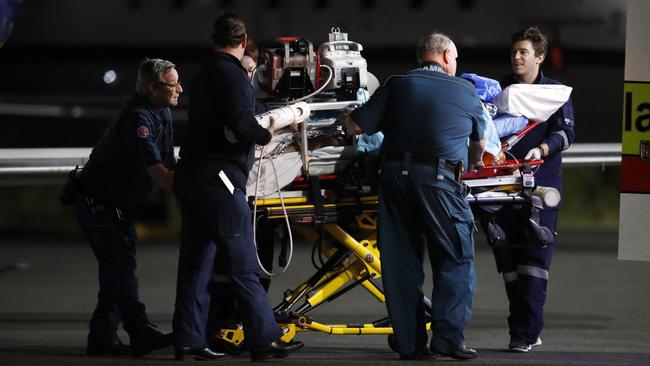 Injured workers from an explosion at Grosvenor coal mine at Moranbah pictured arriving at the RACQ Lifeflight, Brisbane. (AAP Image/Josh Woning)