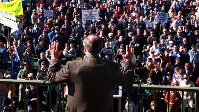 John Howard’s bulletproof vest bulges beneath his suit jacket during his ‘courageous’ speech at a gun rally in Sale, Victoria, in 1996.