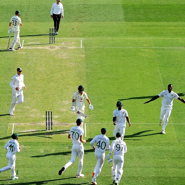 Kagiso Rabada celebrates David Warner’s wicket on day two with the green pitch in the background.