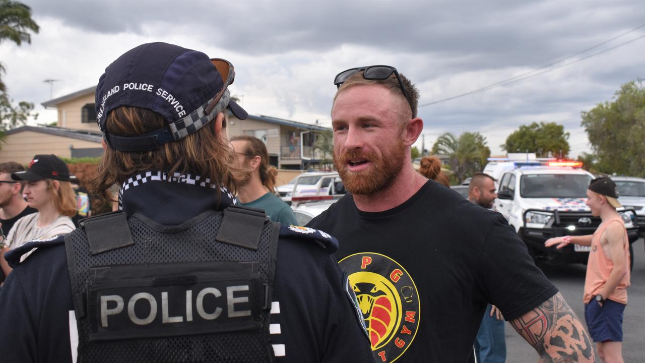 Torin O'Brien speaking with Rockhampton police during the community rally.