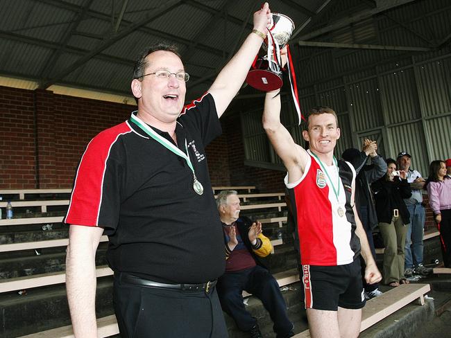 Richard Houston (left) lifts the 2007 premiership cup with club captain Shaun Cotter. Picture: Dale Mann