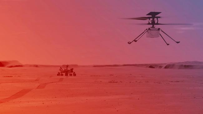 NASA’s Ingenuity Helicopter flying on Mars. In the background is the Perseverance rover. Picture: AFP / NASA