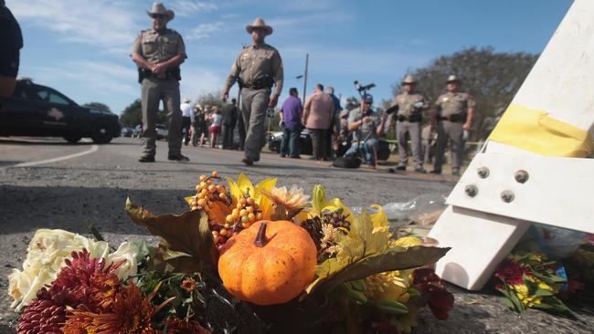 Flowers are placed at a police barricade near the First Baptist Church of Sutherland Springs where gunman Devin Patrick Kelly killed 26 people and wounded 20 others. Picture: Getty Images