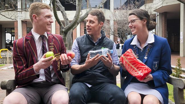 Nic Draper from Scotch Oakburn, Stuart Churton from Zambrero and Elizabeth Reeve from Launceston Church Grammar School are ready to pack 30,000 lunches next week for Tasmanians in need. Picture: PATRICK GEE