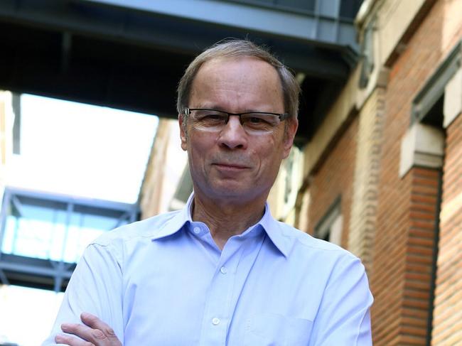 French economist and Nobel Prize laureate Jean Tirole poses for photographers outside his office at the Toulouse School of Economics in Toulouse, southern France, Monday, Oct. 13, 2014. Tirole won the Nobel prize for economics Monday for research on market power and regulation that has helped policy-makers understand how to deal with industries dominated by a few powerful companies. (AP Photo/Fred Scheiber)