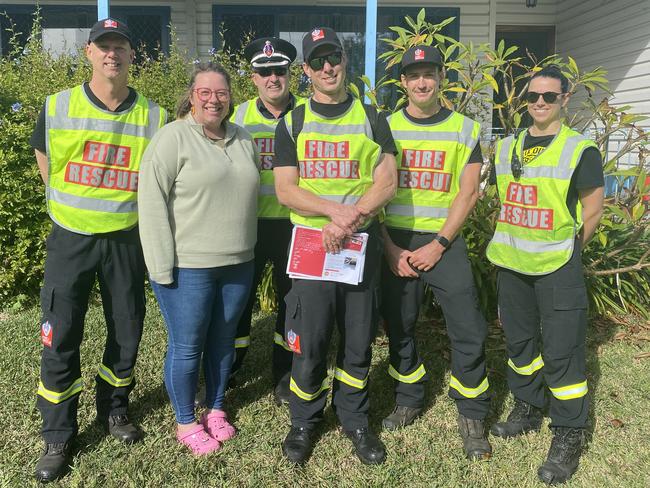 Senior Firefighter Rhett Davis, Superintendant of metropolitan South 3 zone commander Greg Wright, Station officer at Liverpool Fire Station Scott Henderson, Senior FirefigherLuke Marsden and qualified firefigher April Maciejowski with Liverpool resident Amy Bradley.