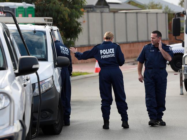 Forensic police are seen in front of a house where the mother and children were discovered. Picture: AAP.