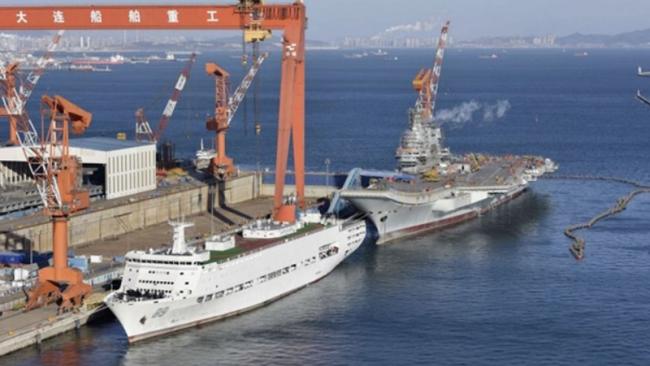 This image shows a Chinese carrier trials support ship berthed in Dalian next to the country’s newest aircraft carrier. Source: Sina