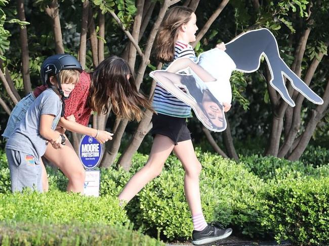 The Affleck children playing with the same cardboard cutout last year. Picture: X17